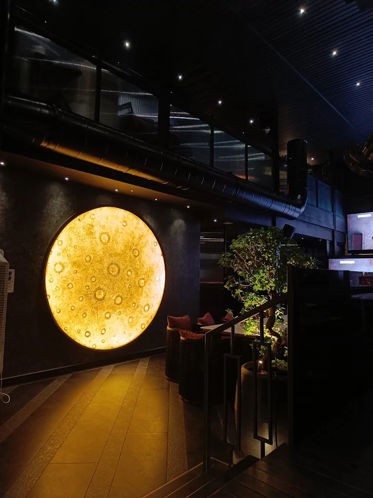 The moon wall — the glowing amber full-moon disc inside Moon.